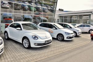 PRAGUE, THE CZECH REPUBLIC, 02.08.2015 - Brand new white Volkswagen Beetle parking in Prague with other VW cars in front of Car Store Volkswagen